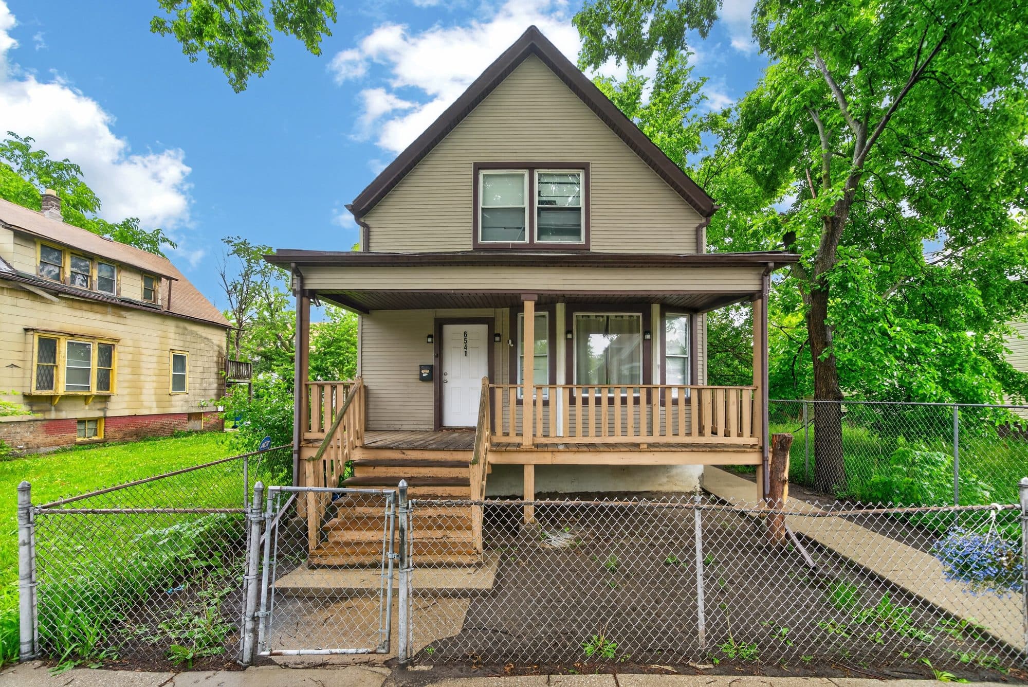 Front exterior real estate photo of a two-story home with porch